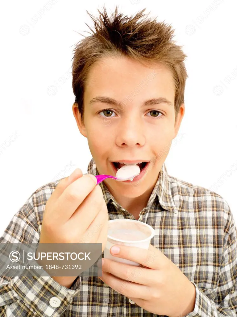 Portrait, boy, teenager eating yoghurt