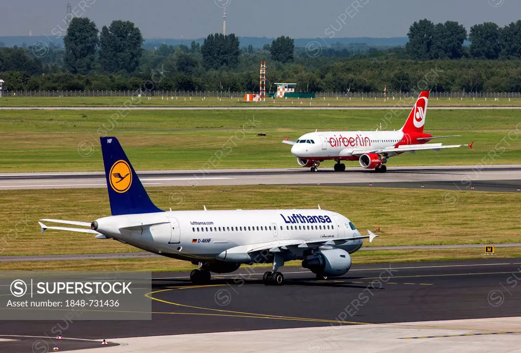 A Lufthansa Airbus A319 on the taxiway and an Air Berlin Airbus A320 after landing at Duesseldorf International Airport, Duesseldorf, North Rhine-West...