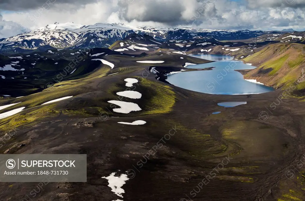 Aerial view, Lake Skyggnisvatn, moss-covered landscape with snow-covered mountains, Icelandic Highlands, Iceland, Europe