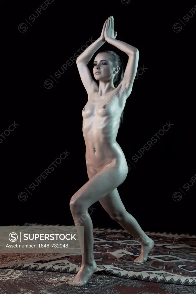 Young woman standing, yoga pose, nude
