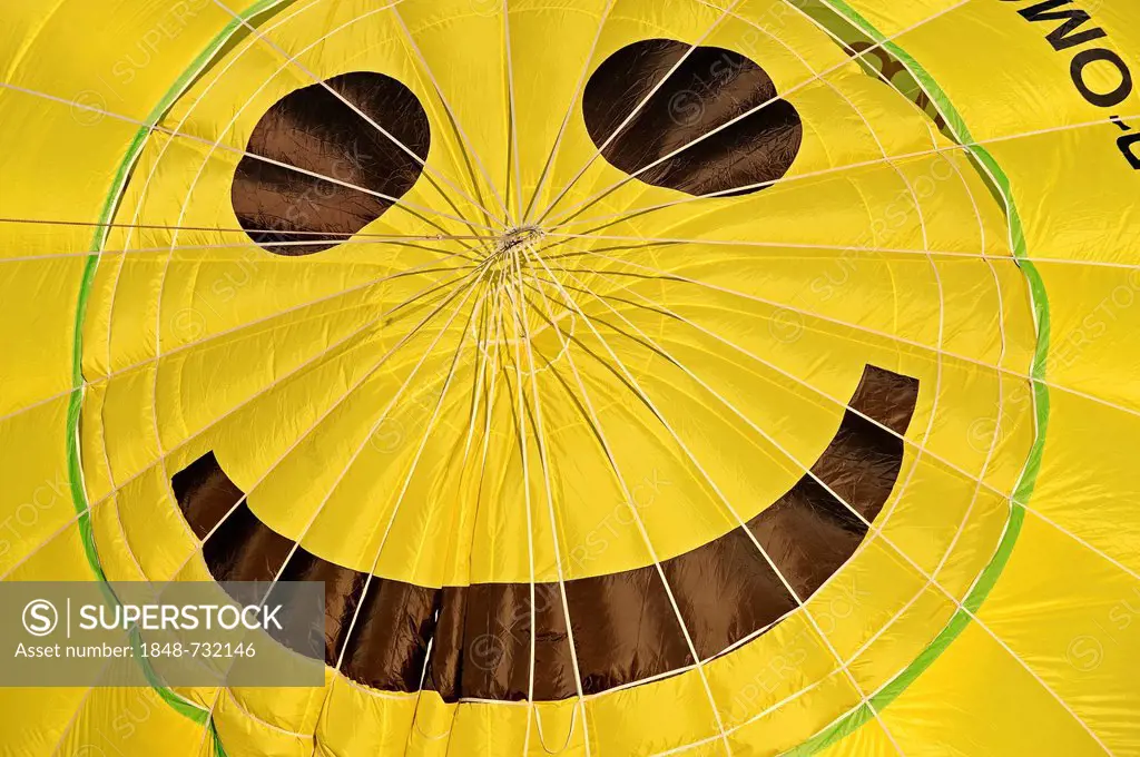 Envelope of a hot air balloon with a smiley face at the Montgolfiade ballon festival in Muenster, North Rhine-Westphalia, Germany, Europe, PublicGroun...