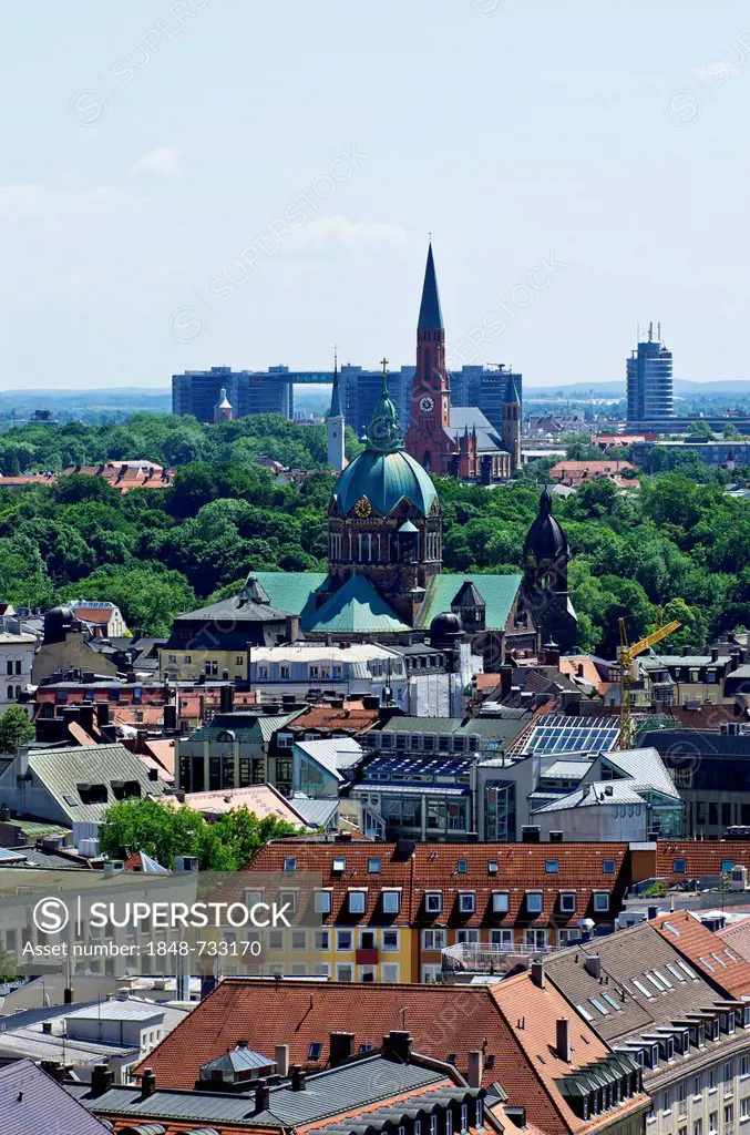 View over the roofs of Munich as seen from the steeple of the Church of St. Peter, Church of St. Lukas, Mariahilf-Kirche church and a complex of build...
