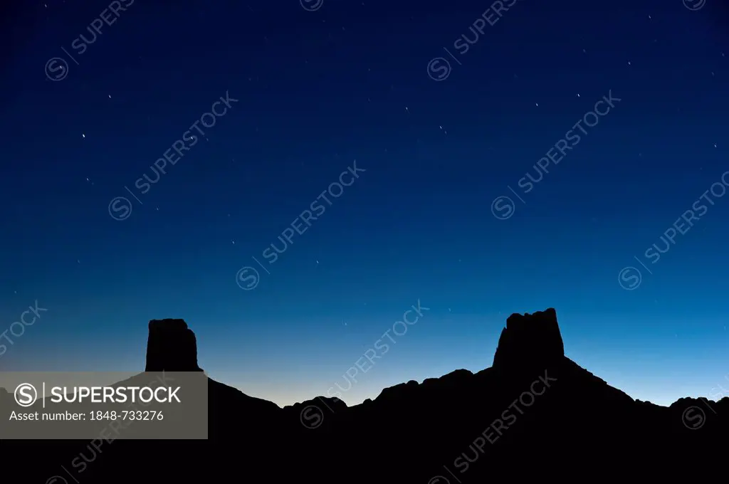 Starry sky above the imposing stone rock formations named Madame and Monsieur, Bab'n Ali, Jebel Sarhro or Little Atlas mountain range, southern Morocc...