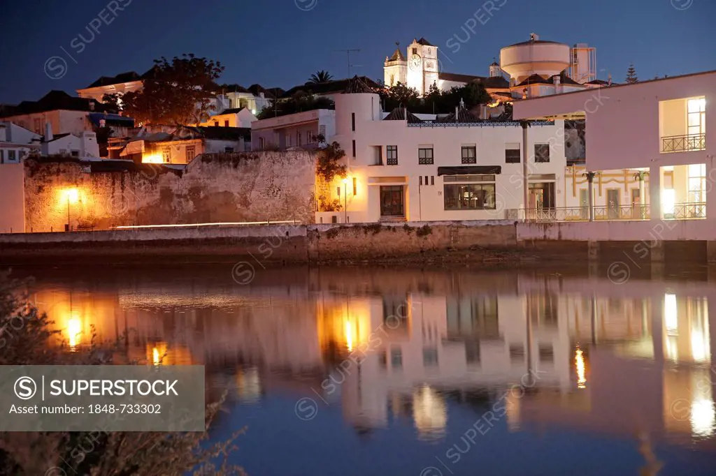 The lights of the old town are reflected in the Gilao river, Tavira, Algarve, Portugal, Europe