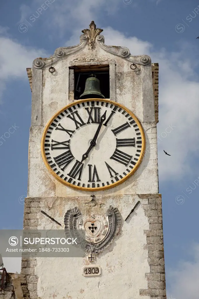 Bell tower with clock of the Santa Mario do Castelo church in the old town of Tavira, Algarve, Portugal, Europe