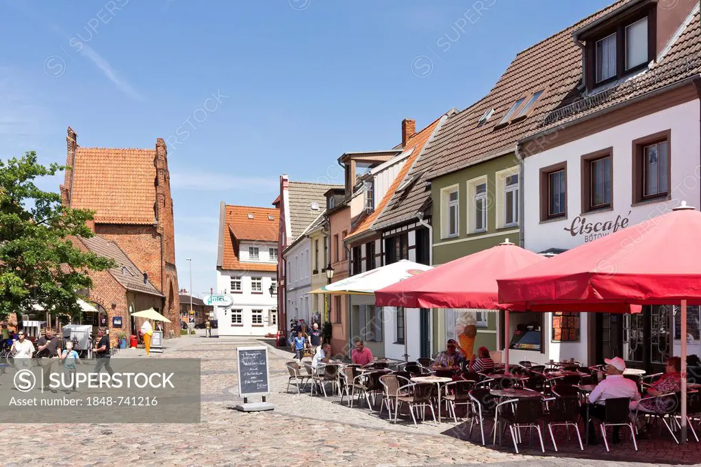 An ice cream parlour and commercial buildings next to the Wassertor gate near the old port, Wismar, Mecklenburg-Western Pomerania, Germany, Europe