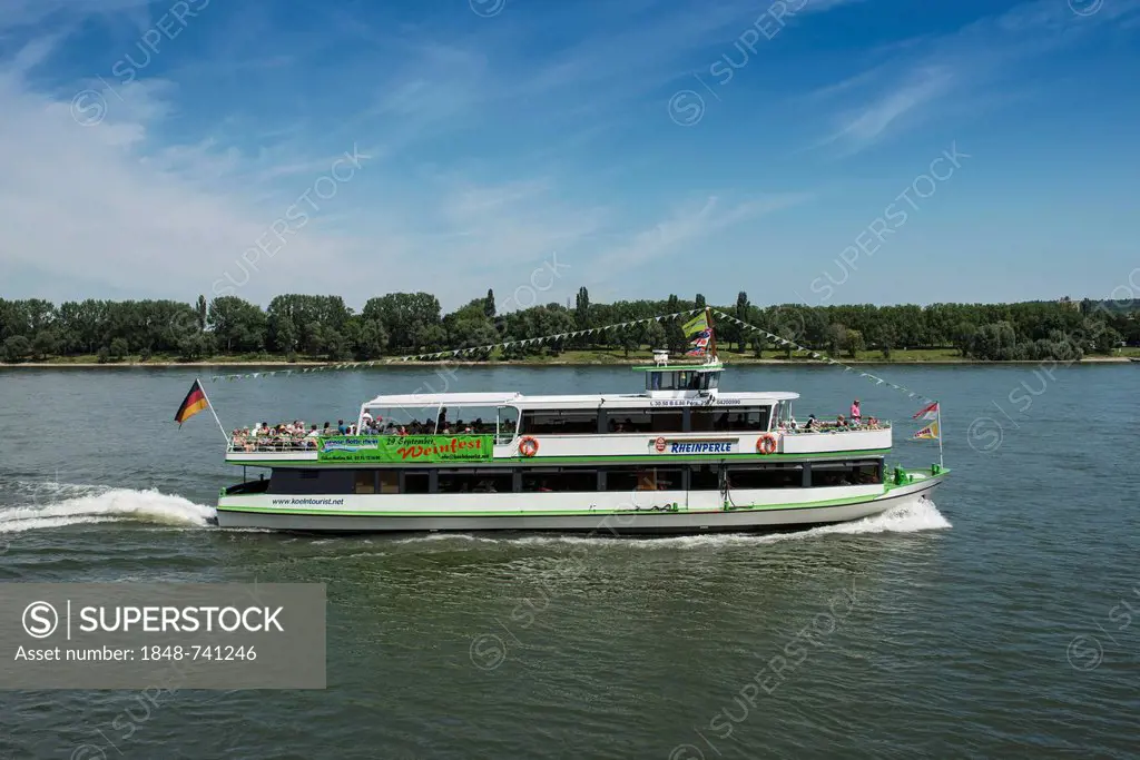 Rheinperle, a crowded excursion boat of the Koelntourist Personenschiffahrt am Dom GmbH shipping company traveling on the Rhine river near Cologne, No...