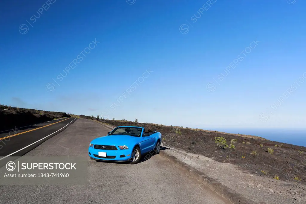 Sky-blue Ford Mustang convertible by the sea, Big Island, Hawaii, USA