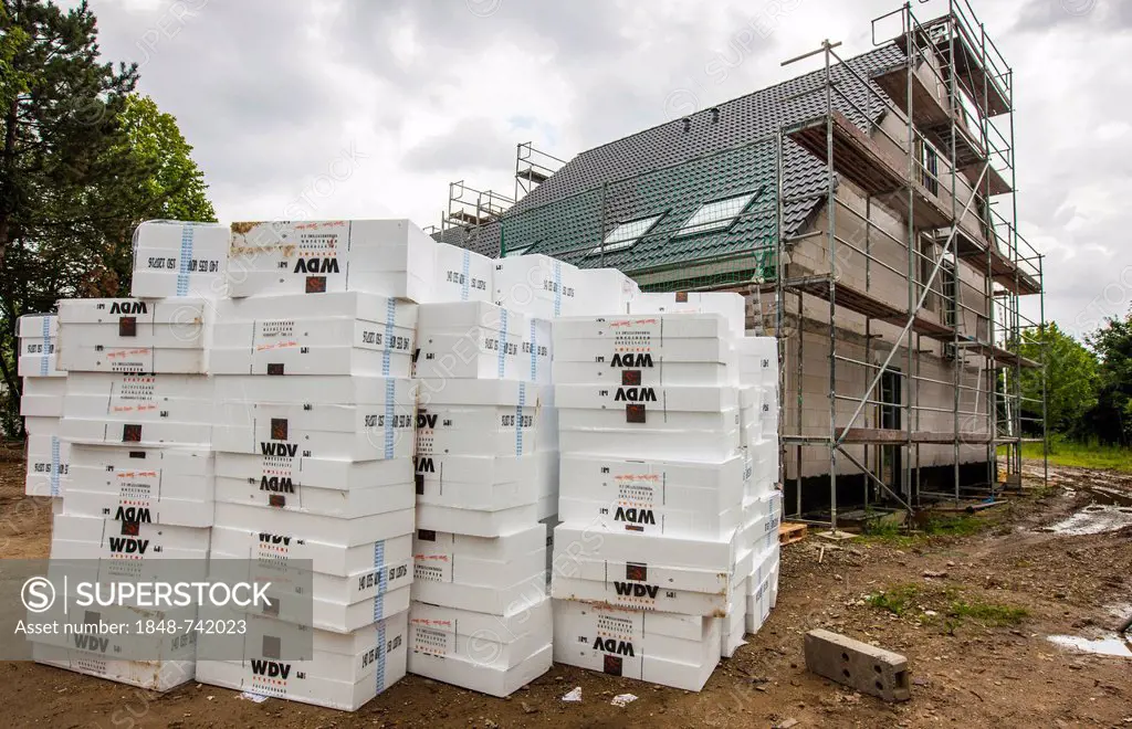 New construction of a single-family house, a stack of insulation material lying on the construction site