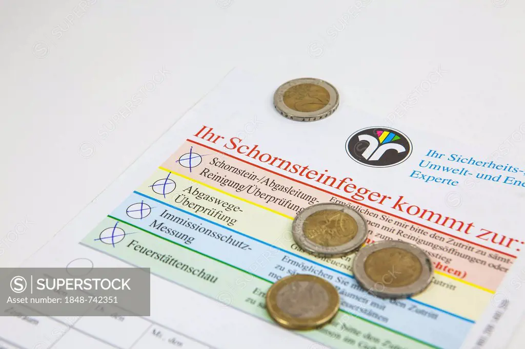Coins on an announcement form from a chimney sweep to control and clean the chimney exhaust pipe, to do an inspection for the CO check with pollution ...