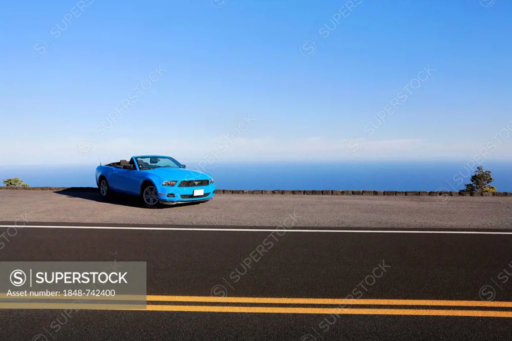 Sky-blue Ford Mustang convertible by the sea, Big Island, Hawaii, USA