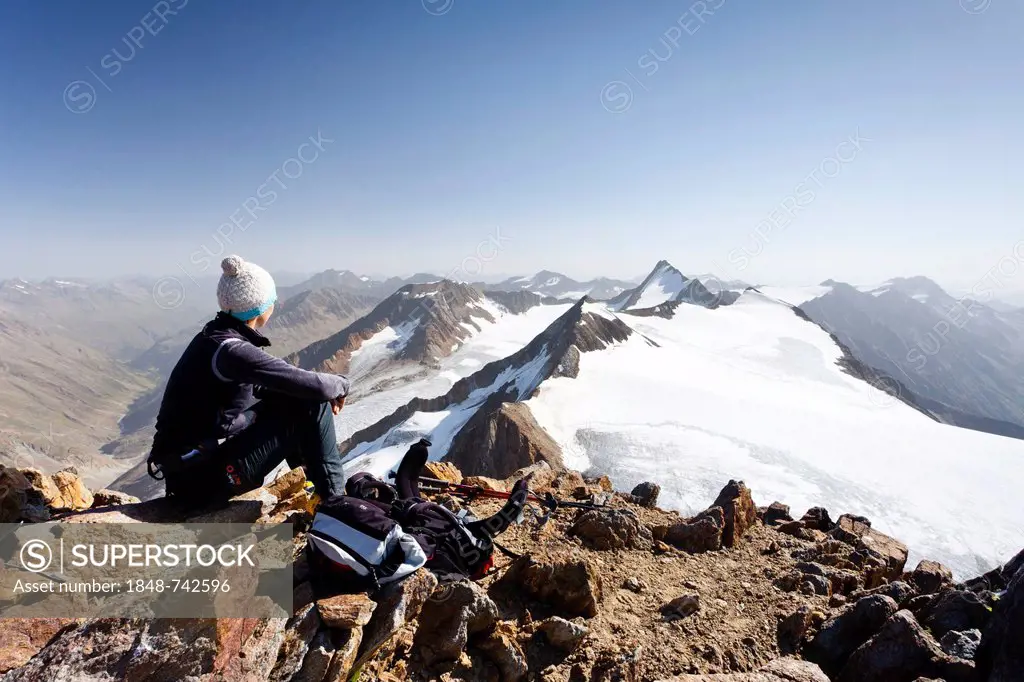 Hiker on th summit of Similaun Mountain on the Niederioech Ferner in Val Senales above the Fernagt Reservoir, Marzell Spitz Mountain and Hintere Schwa...