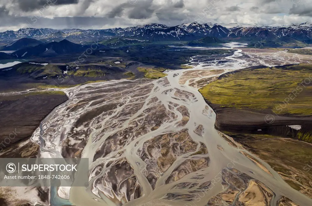 Aerial view, Tungnaá braided river, rhyolite mountains partially covered with snow, Landmannalaugar, Fjallabak conservation area, Icelandic Highlands,...