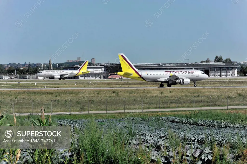 Germanwings D-AKNP Airbus A319-112 landing at Stuttgart Airport, with Germanwings D-AKNN Airbus A319-112 which has already landed at the rear, Stuttga...