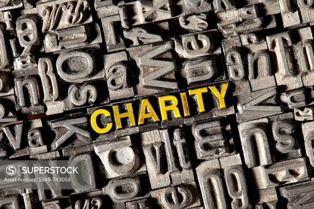 Old lead letters forming the word charity