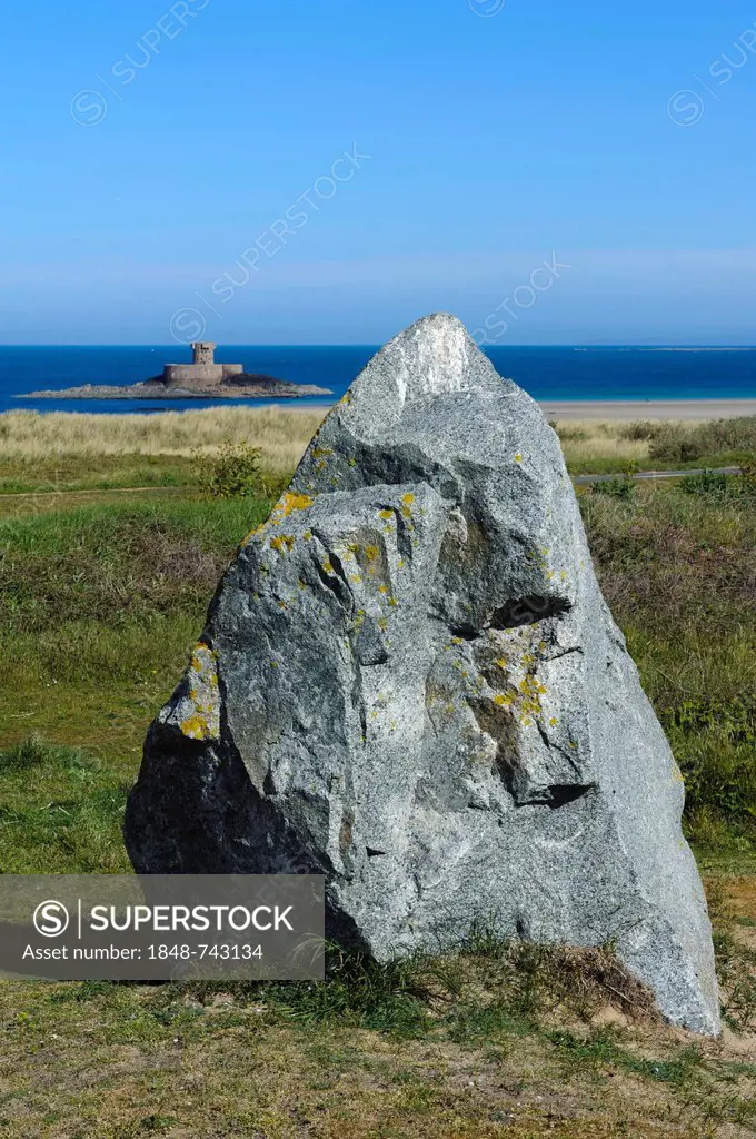 A menhir and the La Rocco Tower at the back, southern St. Ouen's Bay, Jersey island, Channel Islands