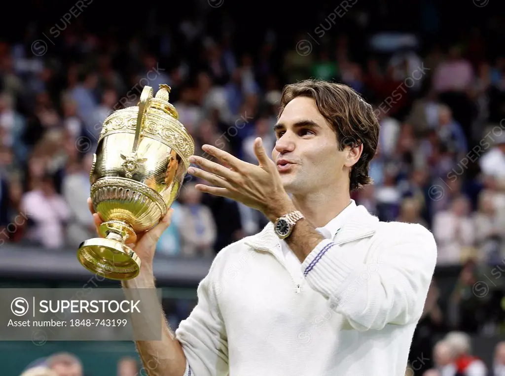 Winners ceremony, Roger Federer, SUI, holding the trophy, throwing a kiss in the direction of his family, men's final, Wimbledon Championships 2012 AE...
