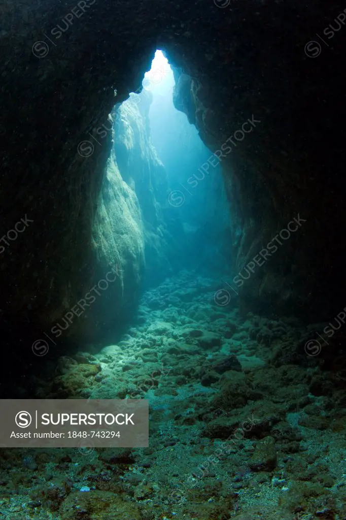 Light shines into a lava tube under water, Kohala Coast, Big Island, Hawaii, USA