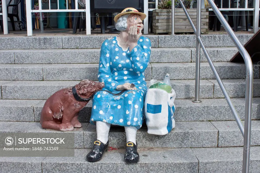Elderly woman with a dog, sculpture on stairs, Heringsdorf, Usedom Island, Mecklenburg-Western Pomerania, Germany, Europe