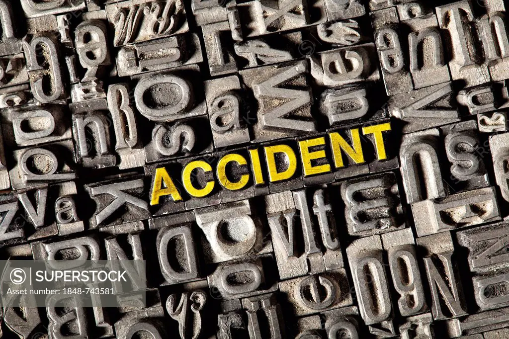Old lead letters forming the word accident