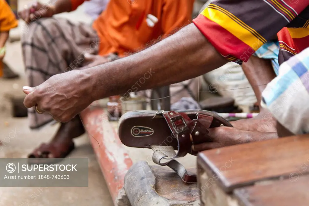 Cobbler sewing sandals, Old Dhaka, Dhaka, Bangladesh, South Asia