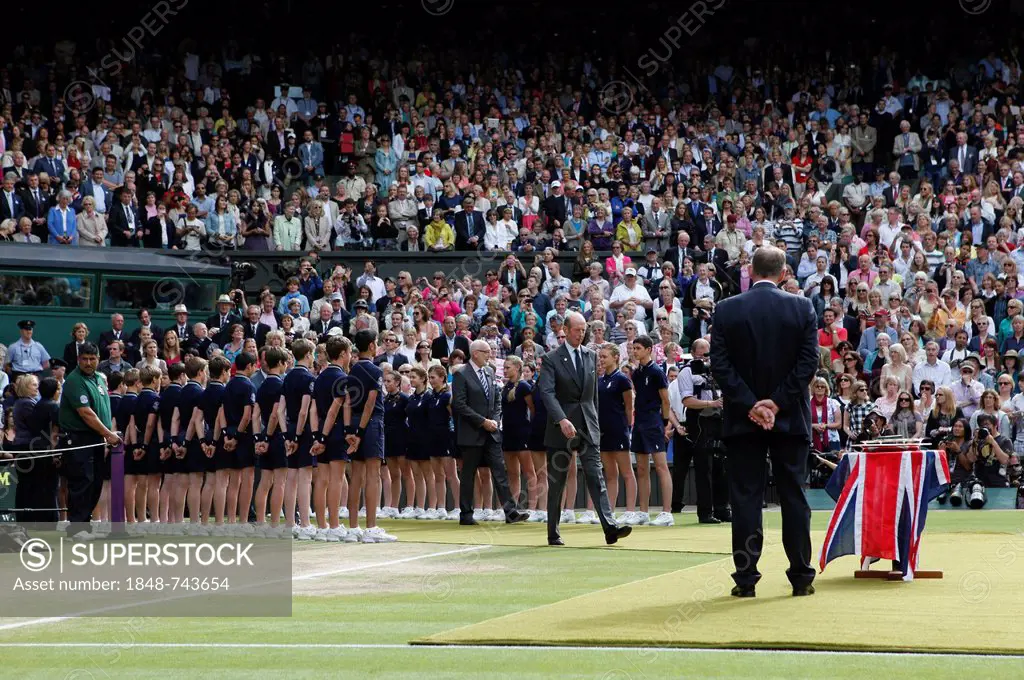 The Duke of Kent passing through a lane of ball kids on Centre Court to attend the awards ceremony, Wimbledon Championships 2012, AELTC, London, ITF G...