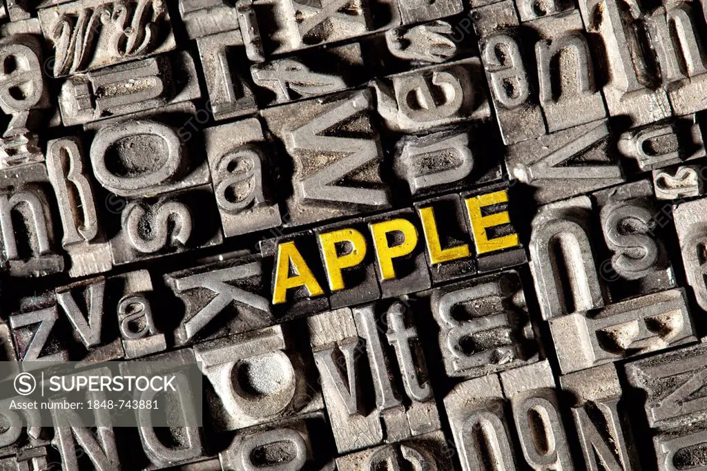 Old lead letters forming the word apple