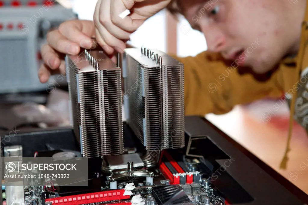 Young man assembling a computer