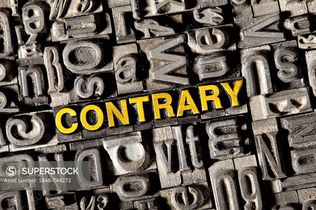 Old lead letters forming the word CONTRARY