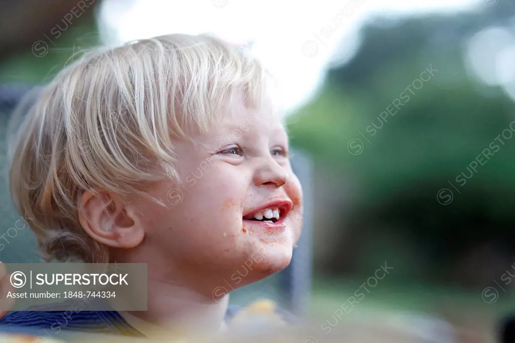 Young boy with his mouth smeared with chocolate