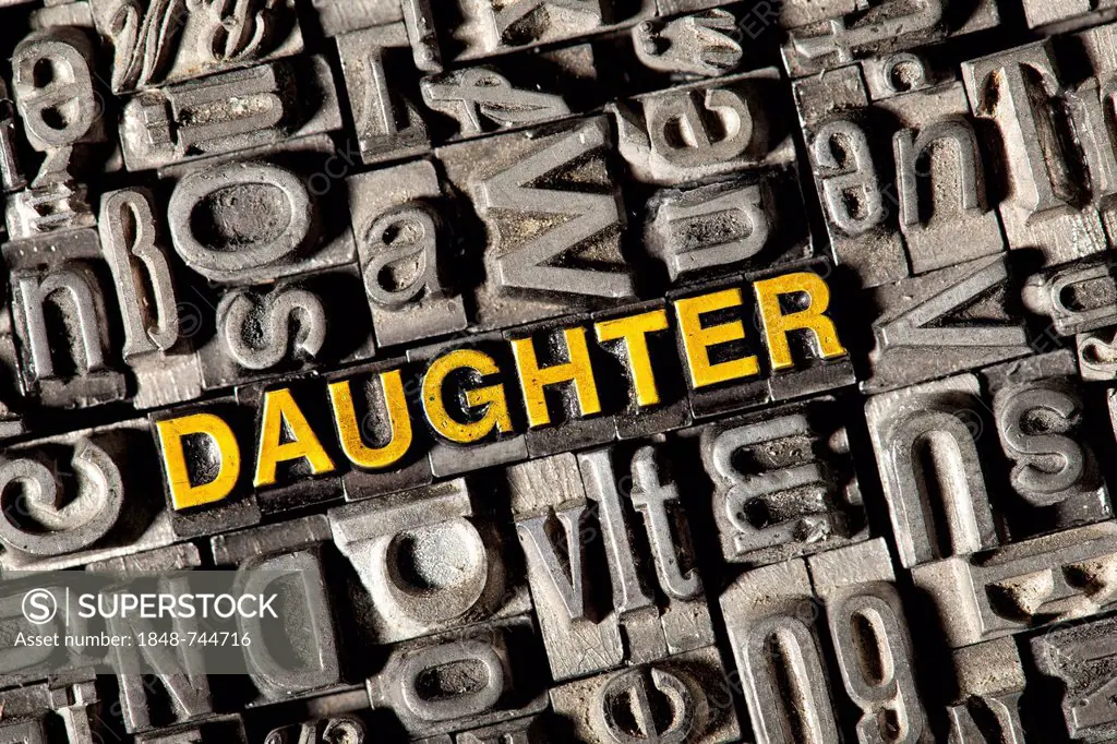 Old lead letters forming the word DAUGHTER