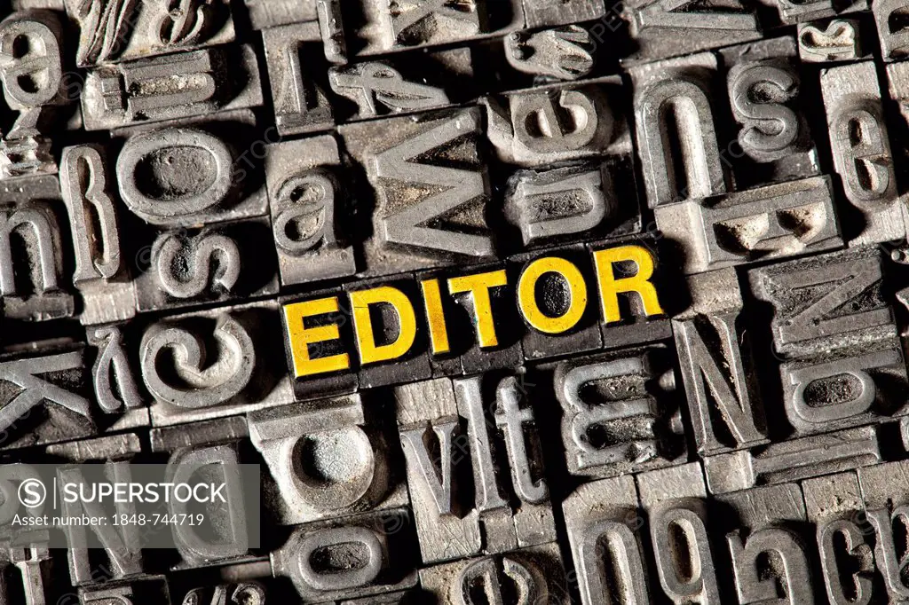 Old lead letters forming the word EDITOR