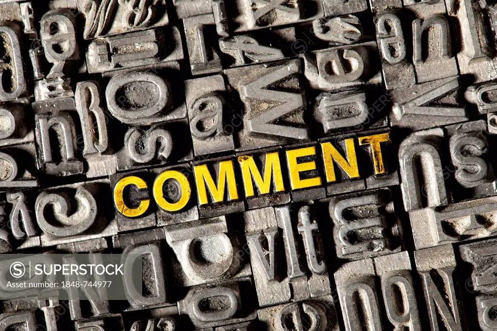 Old lead letters forming the word COMMENT