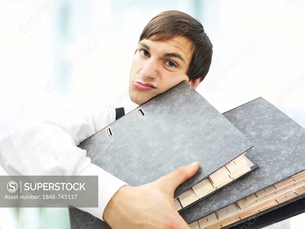 Accountant, clerk at the office, carrying a pile of documents