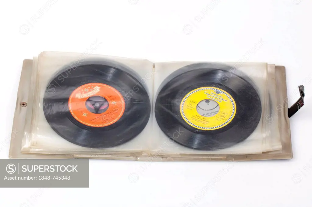 Scrapbook with old records, vinyl singles