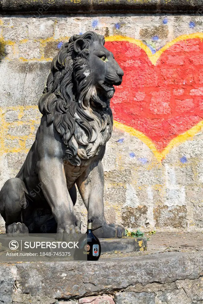 Lion sculpture next to a painted heart, Mainkai, Wuerzburg, Bavaria, Germany, Europe