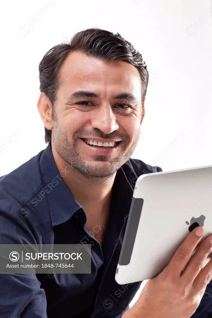 Smiling man holding an iPad