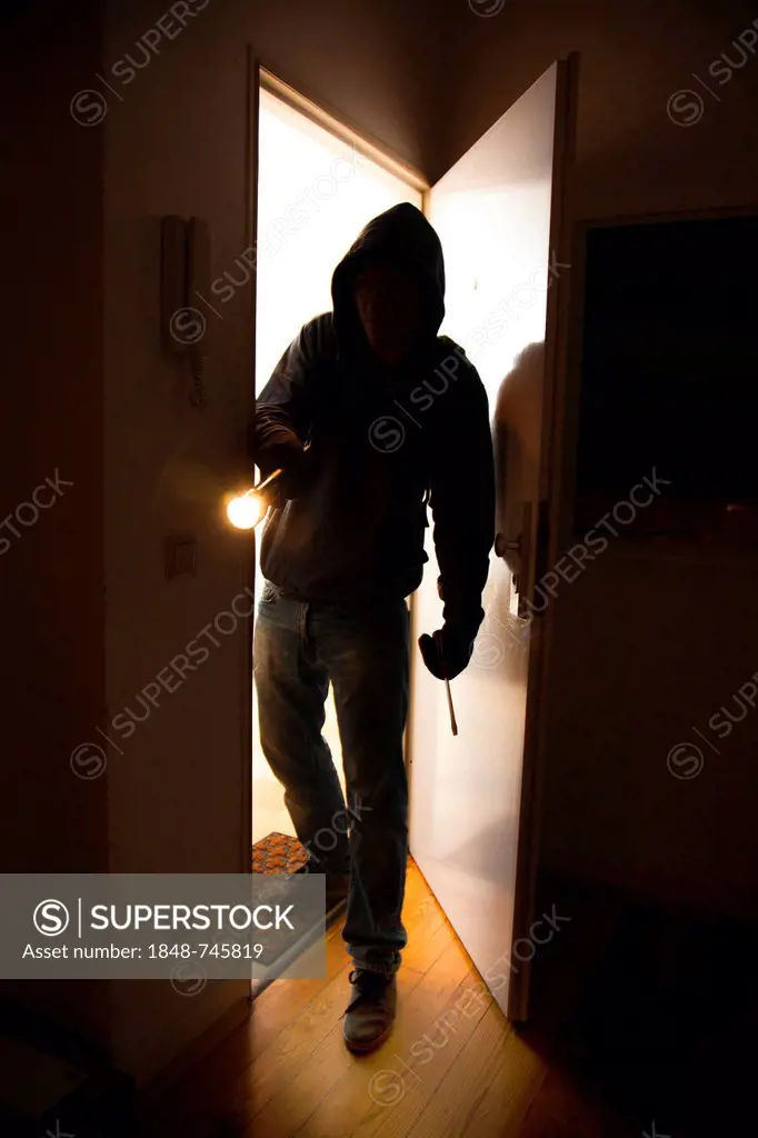 Burglar entering an apartment