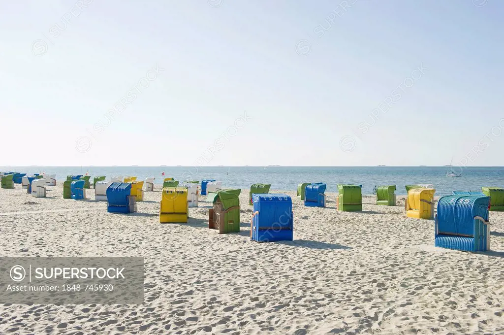 Colourful roofed wicker beach chairs on the beach, Wyk, Foehr, North Frisia, Schleswig-Holstein, Germany, Europe