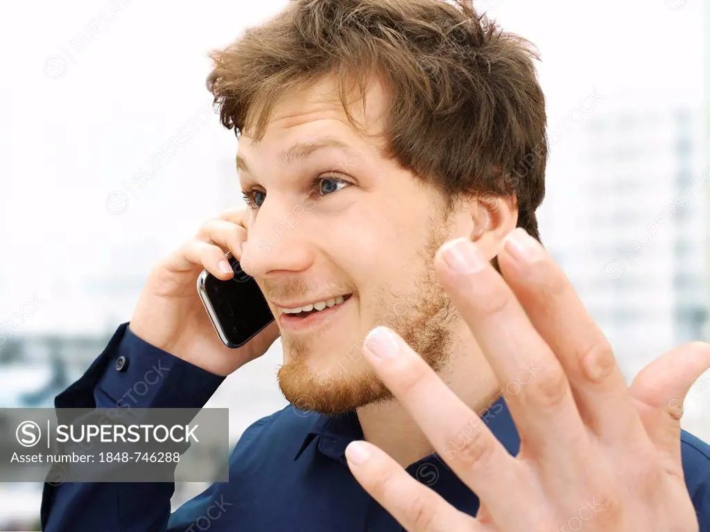 Portrait of a businessman making a telephone call, gesticulating, friendly, optimistic