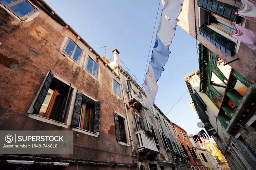 Houses standing close together with clothes drying on clotheslines strung between them, Castello, Venice, Venezia, Veneto, Italy, Europe