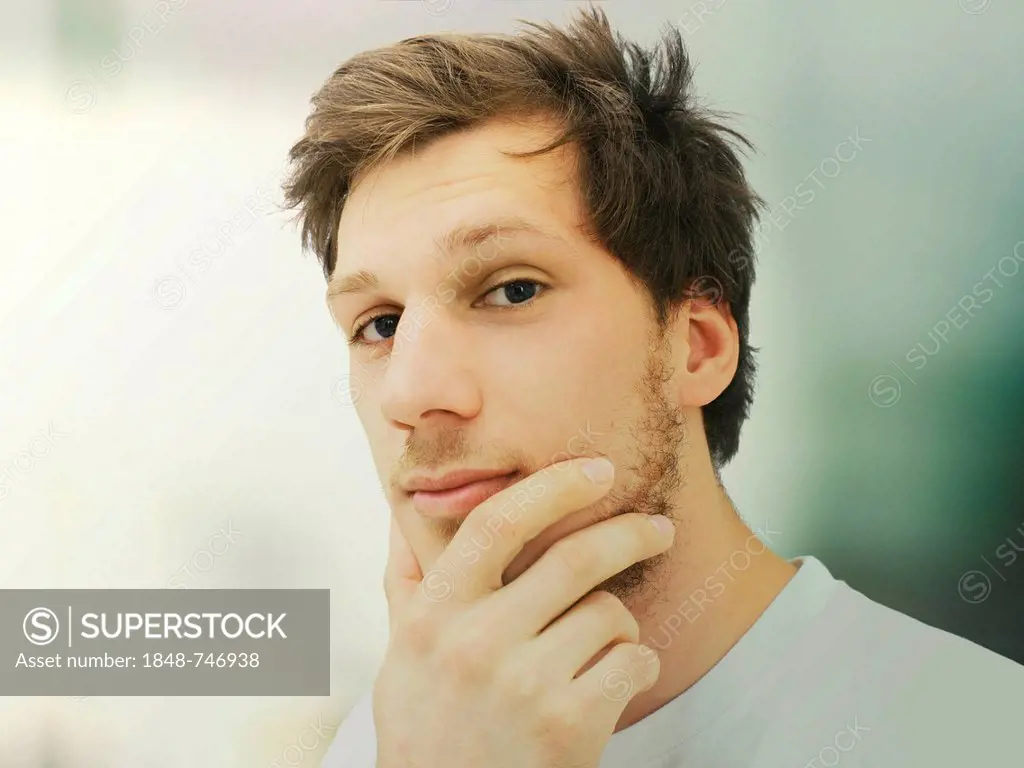Portrait of a young man with a beard, student, serious, relaxed, calm