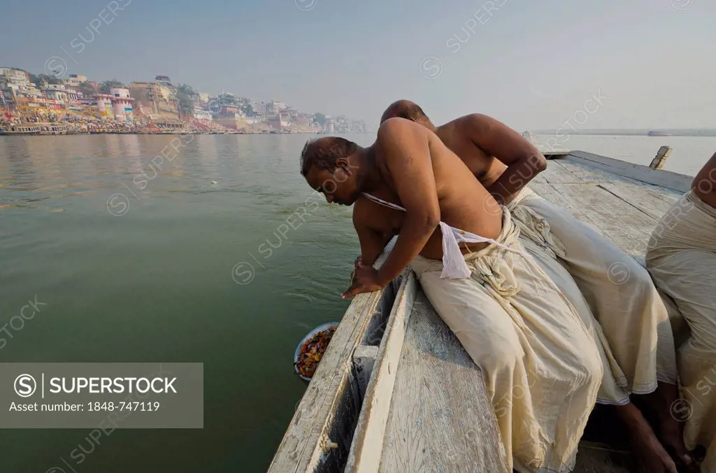 Remains of the cremation of a family member are offered to the holy river Ganges, Varanasi, India, Asia