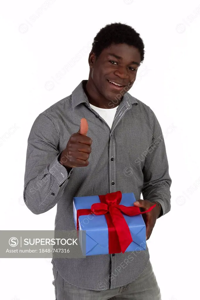 Young black man holding a present, thumbs up