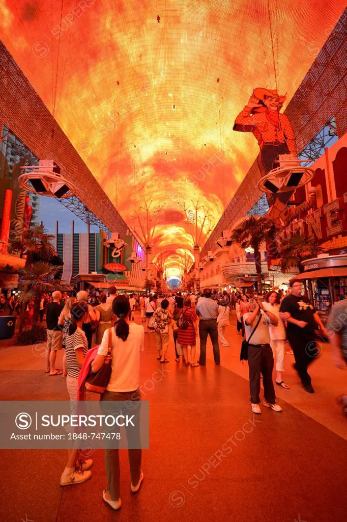 Tourists marvel at a laser show in the neon dome of the Fremont Street Experience in old Las Vegas, Downtown Las Vegas, Nevada, United States of Ameri...