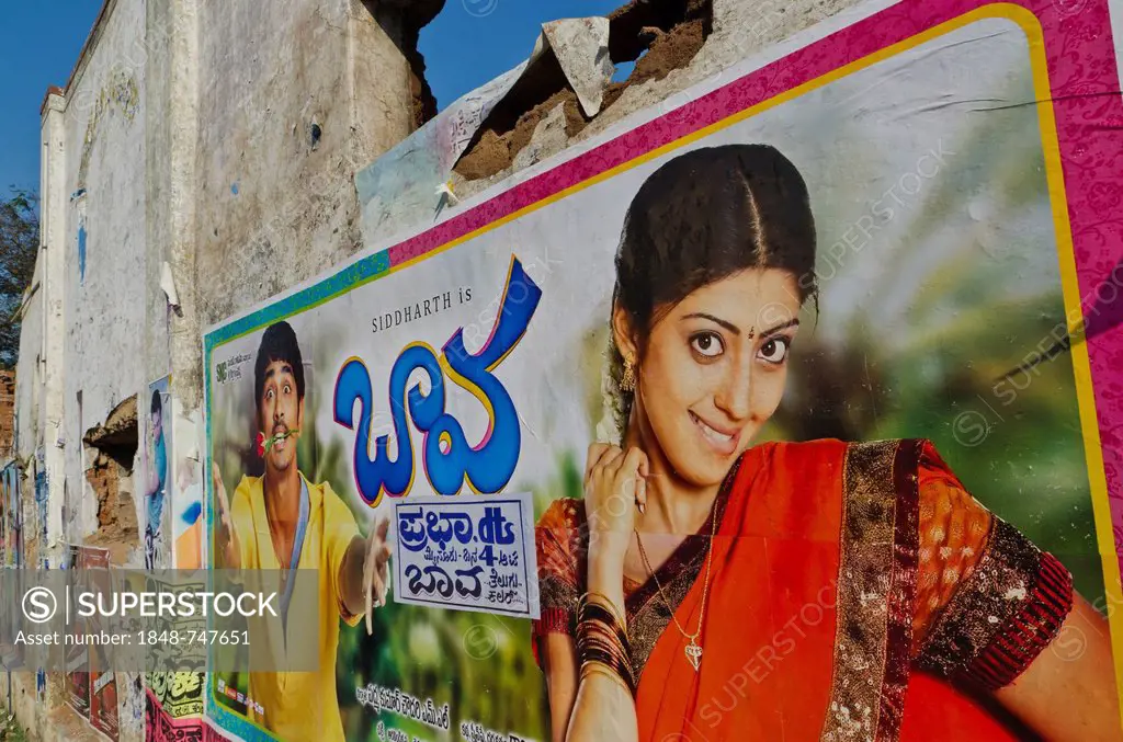 Cinema posters on wall of a broken down house, Mysore, India, Asia