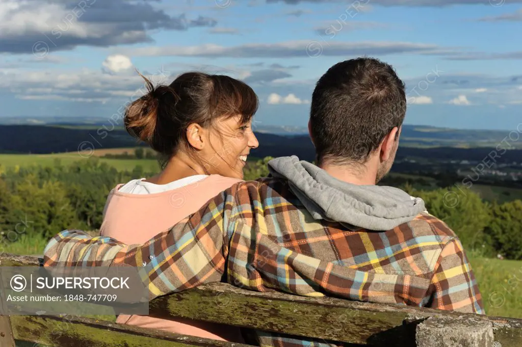 A young couple sitting on a bench, Hegaublick, Baden-Wuerttemberg, Germany, Europe, PublicGround