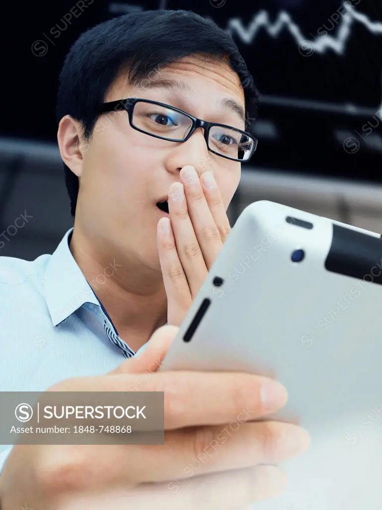 Businessman, Asian, with glasses, iPad, stock exchange, amazed, surprised, excited