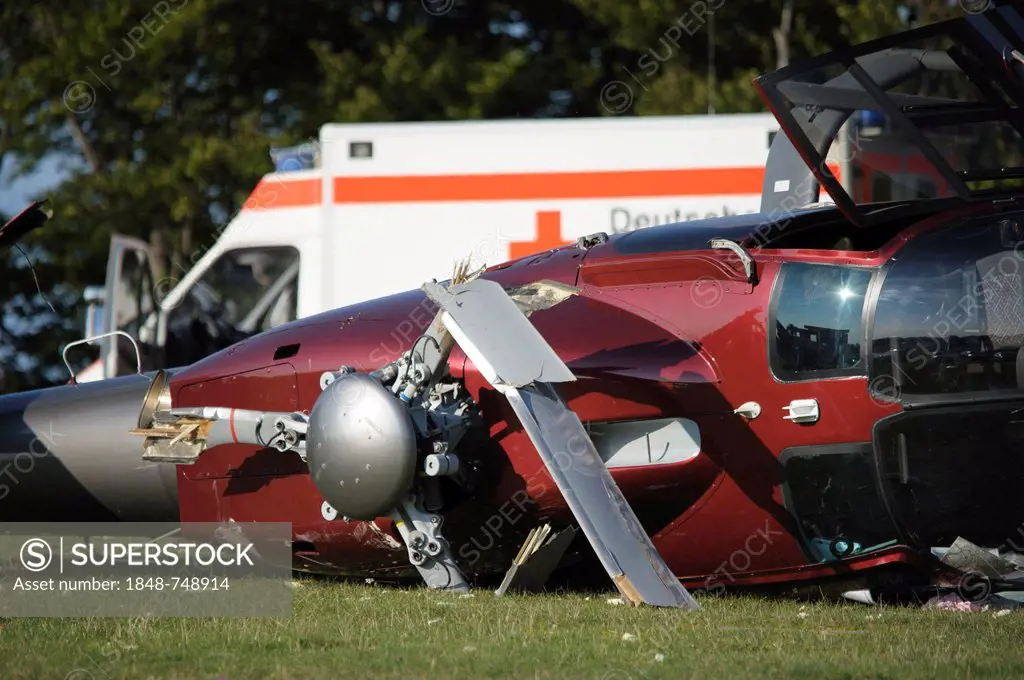 A crashed EC 120 helicopter, an ambulance standing at the back, Metzingen, Baden-Wuerttemberg, Germany, Europe
