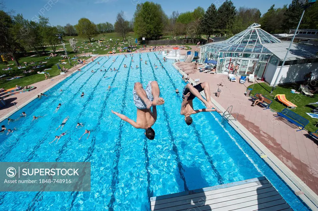 Boys diving into a public swimming pool, Moehringer Freibad, Stuttgart, Baden-Wuerttemberg, Germany, Europe